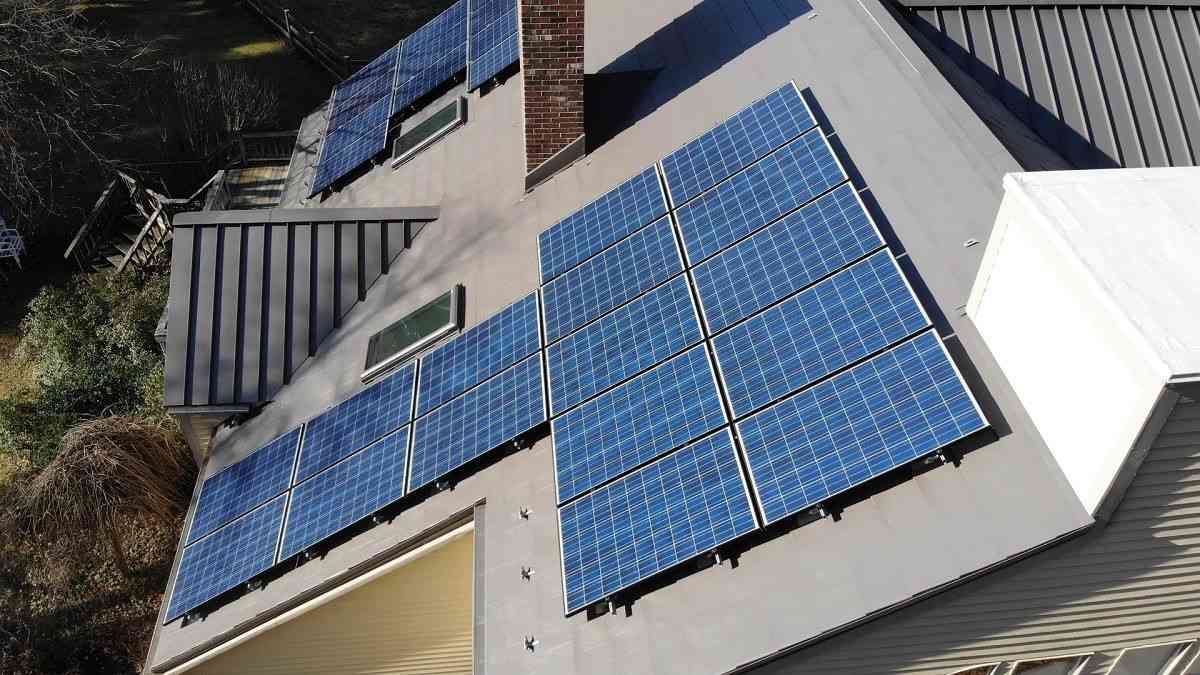 Rooftop solar panel array mounted onto a metal roof system on a residential home.