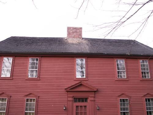 A red house before a roof replacement in MA, CT, NH, RI