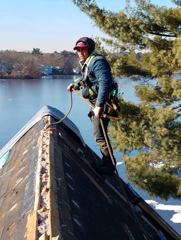 metal roof installer with safety gear