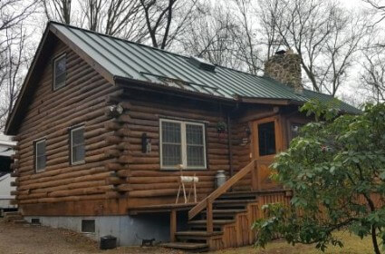 Log Home with Standing Seam Aluminum Metal Roof