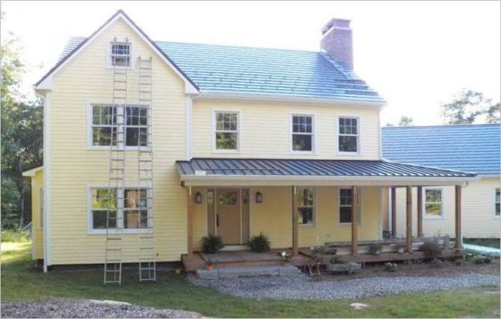 A platinum metal roof over a front porch on a yellow house in MA, CT, NH, or RI