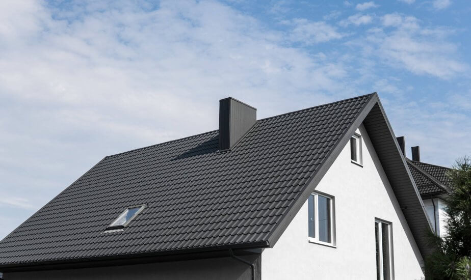 Charcoal Metal Shingle Roofing on cream house in RI