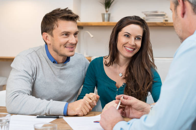 Young couple getting a free roofing consultation