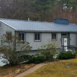 People in New Hampshire prefer metal roofs, including this standing seam metal roof on a ranch home