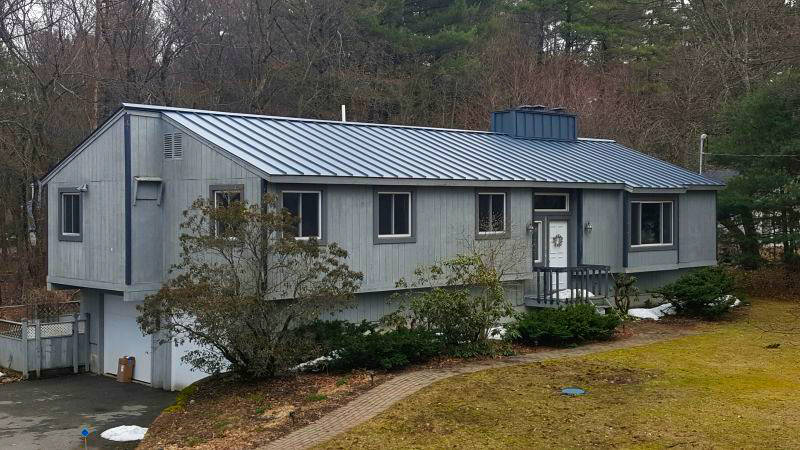 People in New Hampshire prefer metal roofs, including this standing seam metal roof on a ranch home