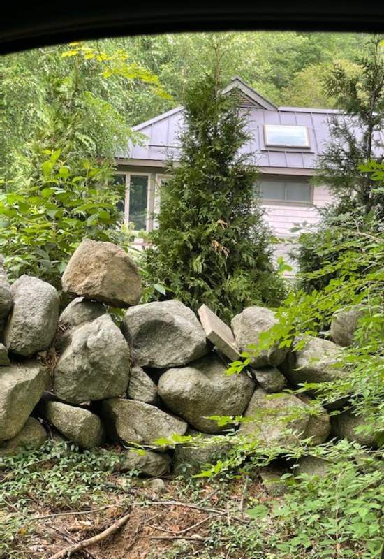 The bunch of big stones in front of homes