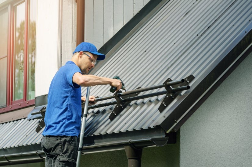 Professional roofing contractor installing a metal roof in Stow, MA