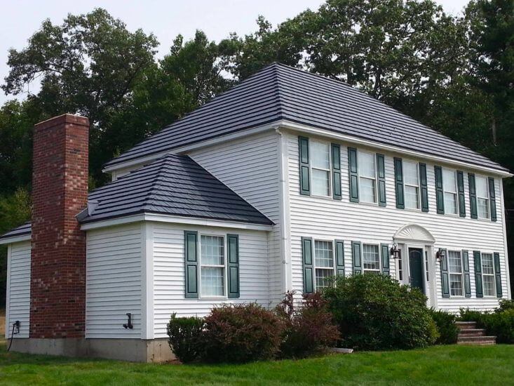 Black metal roof shingles on a white house in CT MA NH RI