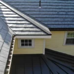 A roof with metal shingles designed to look like slate in the color blue