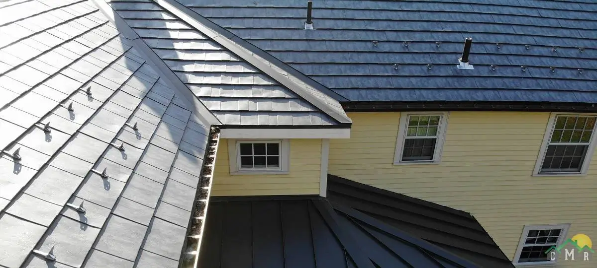 A roof with metal shingles designed to look like slate in the color blue